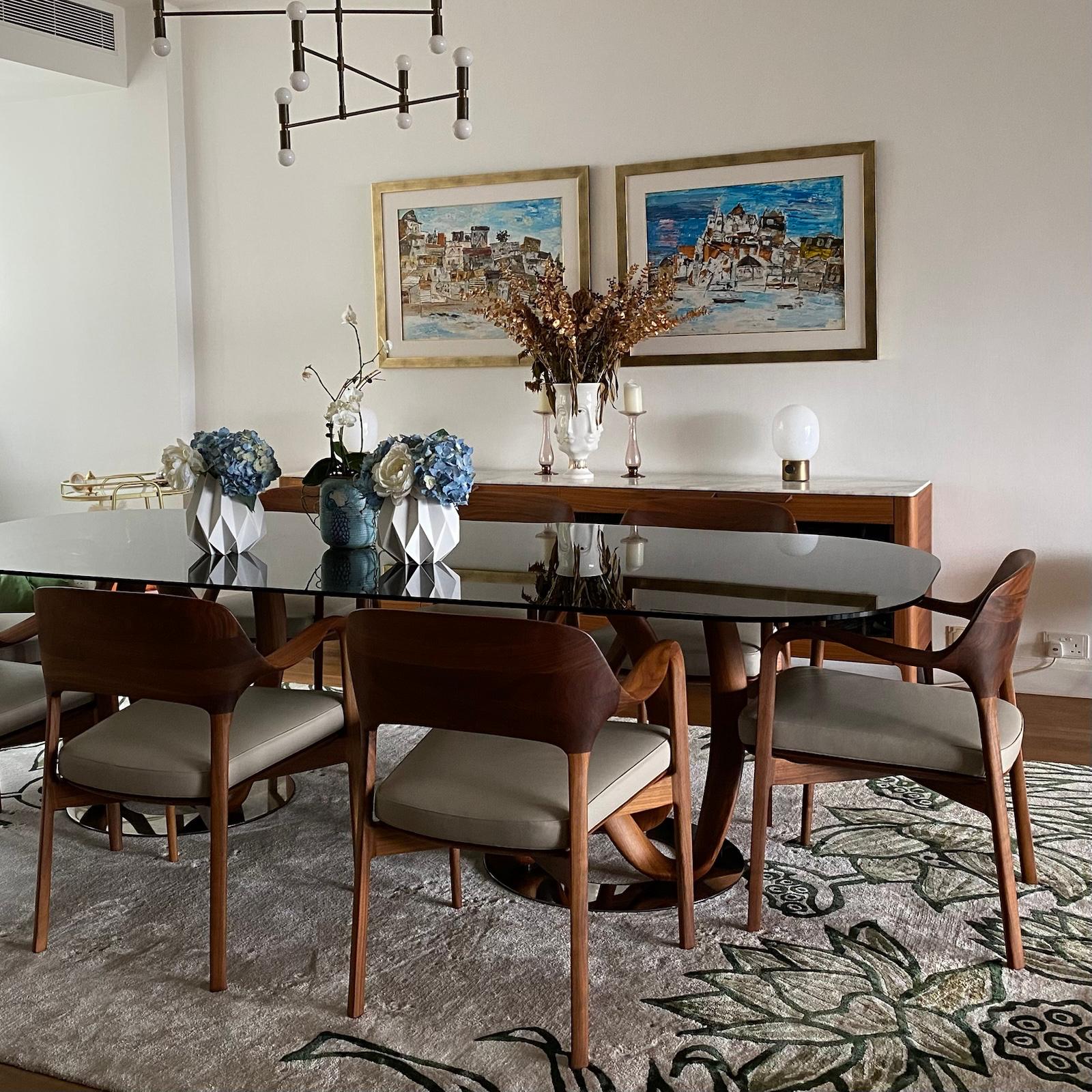 Dining table with blue and white flowers and framed artwork on the wall