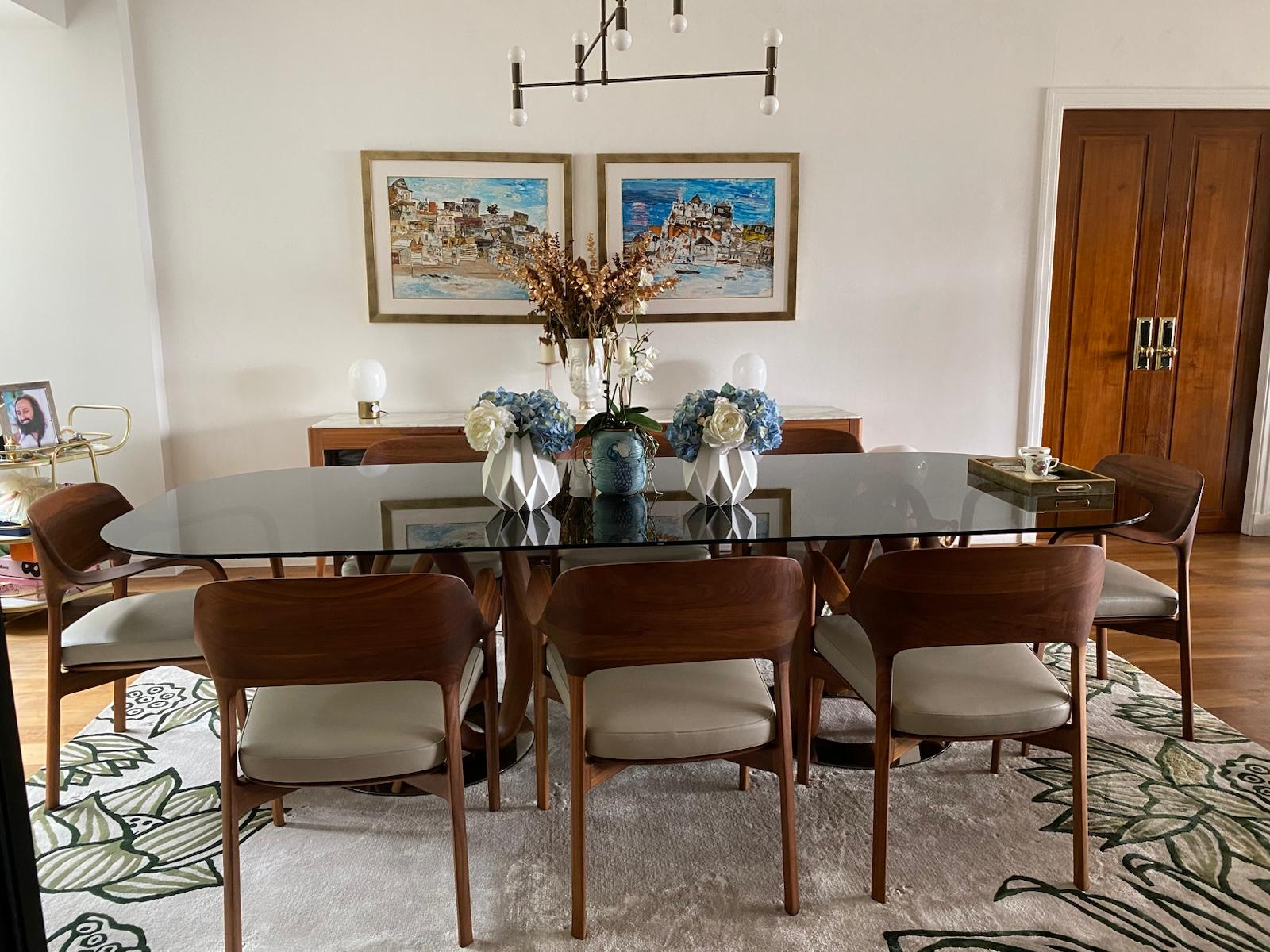 Dining table set with flowers beneath a black pendant near timber double doors